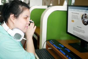 Woman using a screen reader to access the MiAccess website
